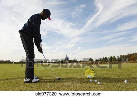 African boy practicing putting on golf course View Large Photo Image Stock Image - African boy practicing putting on golf course. Fotosearch