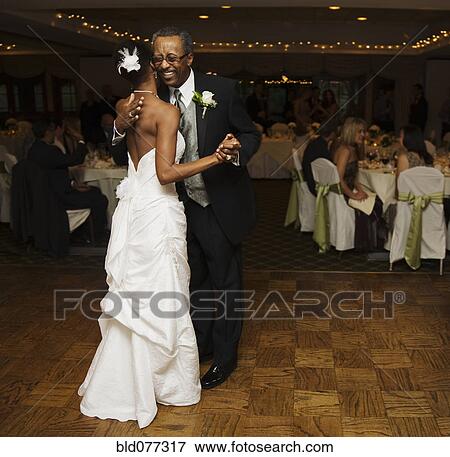 African Bride And Father Dancing At Wedding Reception Stock Photo