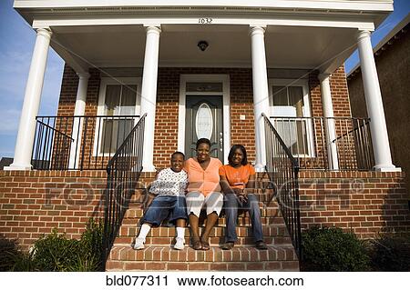 African mother, daughter and son sitting on front stoop of house View Large Photo Image Stock Image - African mother, daughter and son sitting on front stoop of house. Fotosearch