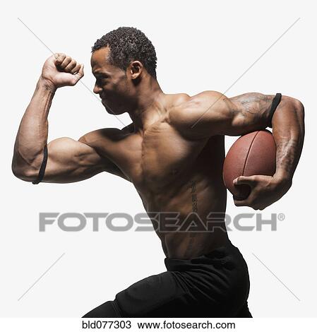 Bare chested football player running with football View Large Photo Image Stock Image - Bare chested football player running with football. Fotosearch