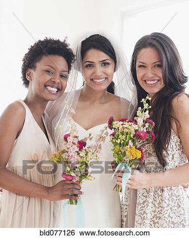 Bride and bridesmaids holding bouquets of flowers View Large Photo Image Stock Photograph - Bride and bridesmaids holding bouquets of flowers. Fotosearch