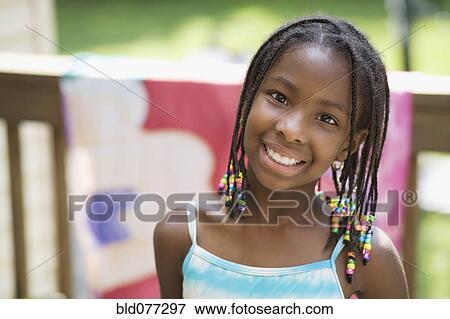 Close up of African girl smiling View Large Photo Image Stock Photo - Close up of African girl smiling. Fotosearch