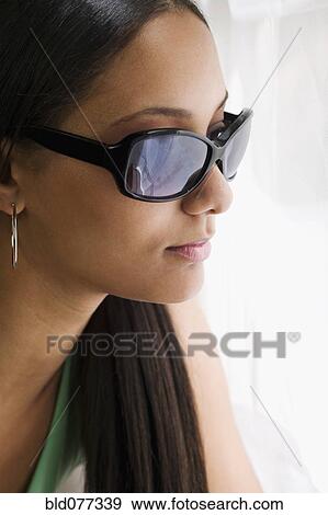 Close up of mixed race woman in sunglasses View Large Photo Image Stock Photo - Close up of mixed race woman in sunglasses. Fotosearch
