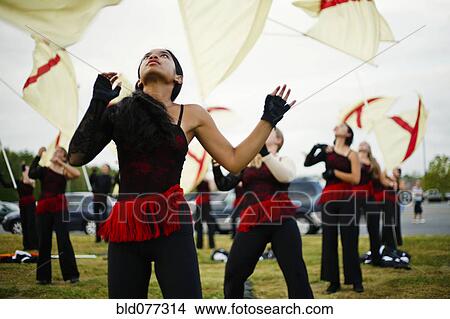 Flag twirlers performing on grass View Large Photo Image Picture - Flag twirlers performing on grass. Fotosearch