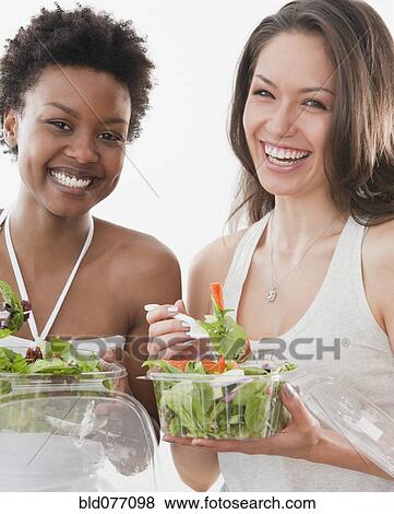 Friends eating salad View Large Photo Image Stock Photo - Friends eating salad. Fotosearch