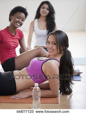 Friends relaxing together after workout View Large Photo Image Stock Image - Friends relaxing together after workout. Fotosearch