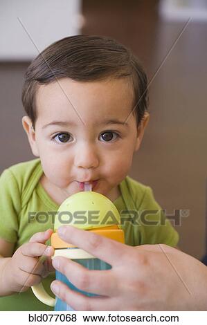 Hispanic baby boy drinking from cup View Large Photo Image Stock Photo - Hispanic baby boy drinking from cup. Fotosearch