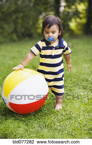 Hispanic baby boy playing with ball View Large Photo Image Stock Image - Hispanic baby boy playing with ball. Fotosearch
