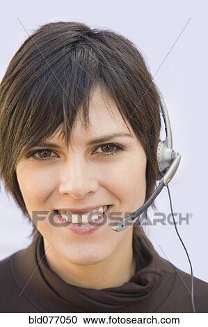 Hispanic businesswoman wearing headset View Large Photo Image Stock Image - Hispanic businesswoman wearing headset. Fotosearch