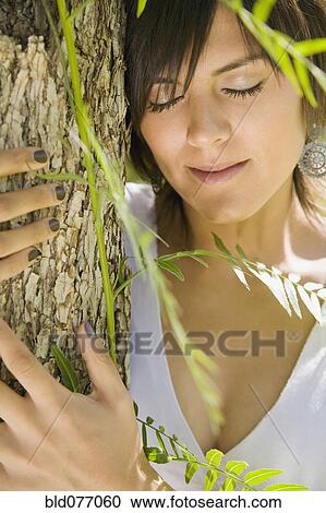 Hispanic woman hugging tree View Large Photo Image Stock Image - Hispanic woman hugging tree. Fotosearch