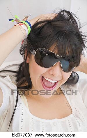 Hispanic woman in sunglasses laughing View Large Photo Image Stock Photo - Hispanic woman in sunglasses laughing. Fotosearch