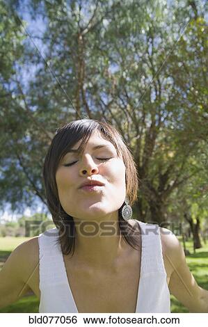 Stock Photograph - Hispanic woman puckering for kiss. Fotosearch