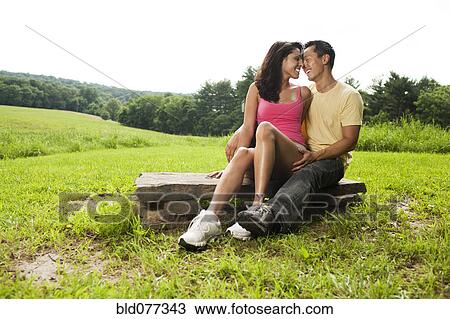 Hispanic woman sitting on rock in field View Large Photo Image Stock Image - Hispanic woman sitting on rock in field. Fotosearch