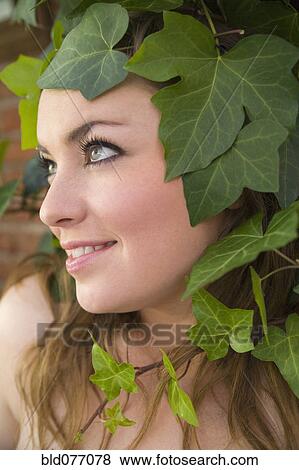 Stock Photo - Hispanic woman standing near ivy. Fotosearch