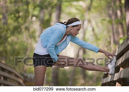 Hispanic woman stretching View Large Photo Image Stock Photo - Hispanic woman stretching. Fotosearch