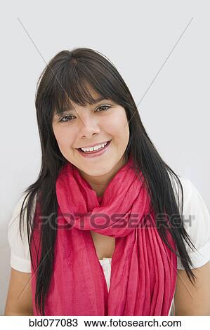 Stock Image - Hispanic woman wearing pink scarf. Fotosearch