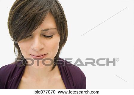 Stock Image - Hispanic woman with eyes closed smiling. Fotosearch