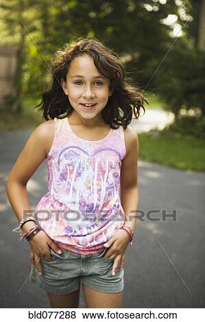 Mixed race girl walking on road View Large Photo Image Stock Photo - Mixed race girl walking on road. Fotosearch