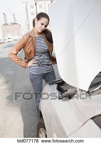 Mixed race woman having car trouble View Large Photo Image Stock Photo - Mixed race woman having car trouble. Fotosearch