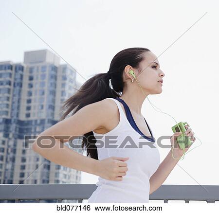 Mixed race woman jogging with mp3 player View Large Photo Image Stock Photograph - Mixed race woman jogging with mp3 player. Fotosearch