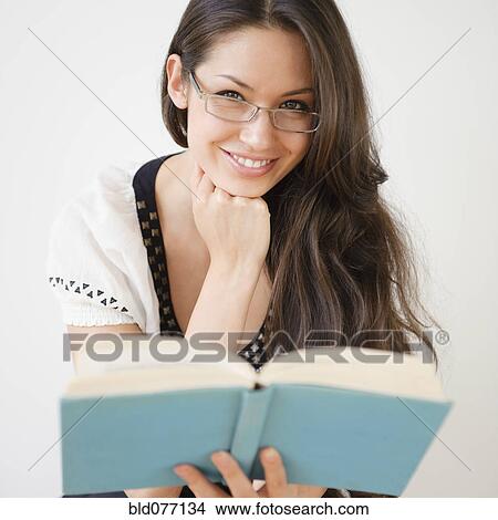 Mixed race woman reading book View Large Photo Image Picture - Mixed race woman reading book. Fotosearch