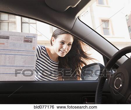 Stock Photograph - Mixed race woman shopping for new car. Fotosearch