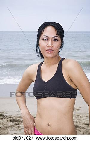 Mixed race woman standing on beach View Large Photo Image Stock Photo - Mixed race woman standing on beach. Fotosearch