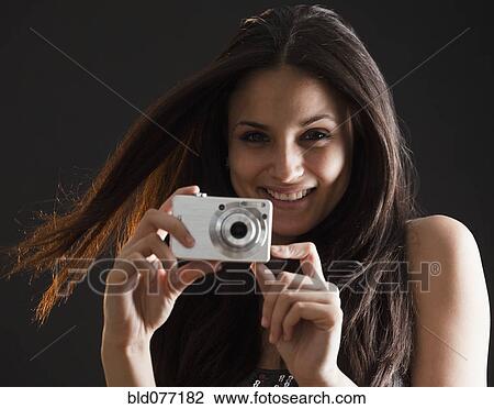 Mixed race woman using digital camera View Large Photo Image Stock Image - Mixed race woman using digital camera. Fotosearch