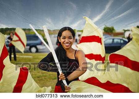 Stock Image - Pacific Islander girl flag twirling. Fotosearch