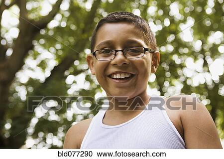 Stock Image - Smiling mixed race boy in eyeglasses. Fotosearch
