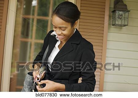 African businesswoman searching for house key View Large Photo Image Stock Image - African businesswoman searching for house key. Fotosearch