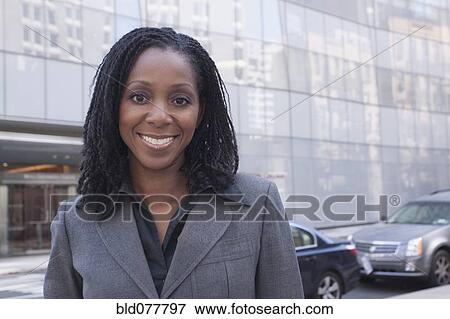 Stock Photo - African businesswoman standing on urban street. Fotosearch