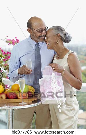 Stock Photograph - African couple celebrating anniversary. Fotosearch
