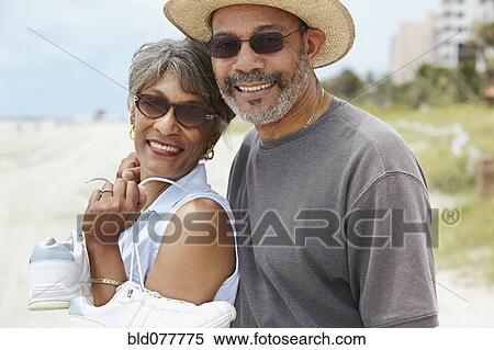 Stock Photography - African couple enjoying beach. Fotosearch