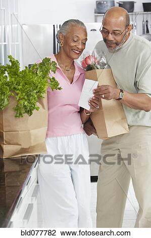 African couple grocery shopping View Large Photo Image Stock Image - African couple grocery shopping. Fotosearch