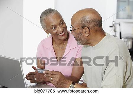 African couple shopping on internet with credit card View Large Photo Image Stock Photography - African couple shopping on internet with credit card. Fotosearch