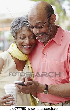 African couple using cell phone View Large Photo Image Stock Image - African couple using cell phone. Fotosearch