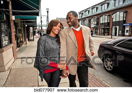 African couple walking on urban sidewalk View Large Photo Image Stock Photo - African couple walking on urban sidewalk. Fotosearch