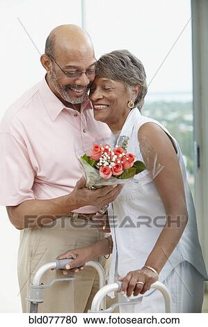 African man giving wife flowers View Large Photo Image Stock Image - African man giving wife flowers. Fotosearch