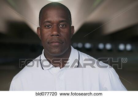 African man standing in parking garage View Large Photo Image Stock Image - African man standing in parking garage. Fotosearch