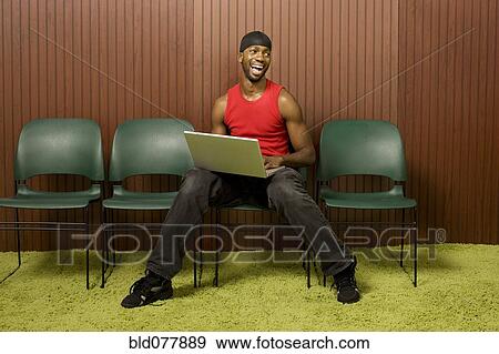 African man using laptop and laughing View Large Photo Image Stock Photo - African man using laptop and laughing. Fotosearch