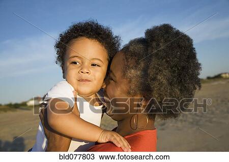 African mother holding baby boy View Large Photo Image Stock Image - African mother holding baby boy. Fotosearch