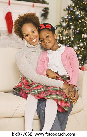 African mother hugging daughter at Christmas View Large Photo Image Stock Image - African mother hugging daughter at Christmas. Fotosearch
