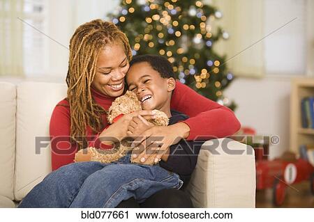 African mother hugging son at Christmas View Large Photo Image Stock Image - African mother hugging son at Christmas. Fotosearch