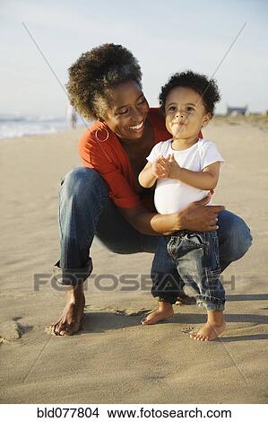 African mother on beach with son View Large Photo Image Picture - African mother on beach with son. Fotosearch