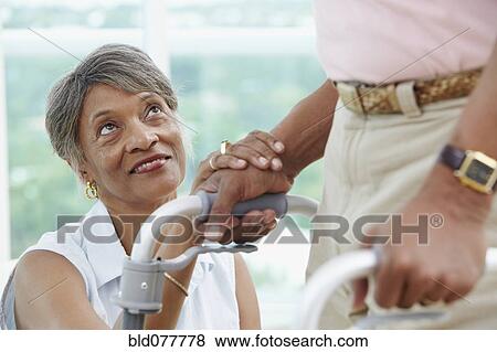African woman encouraging husband using walker View Large Photo Image Stock Photo - African woman encouraging husband using walker. Fotosearch