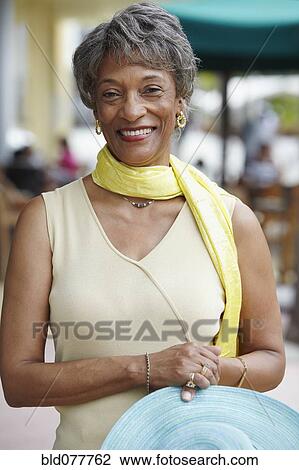 Stock Image - African woman with hat and scarf. Fotosearch