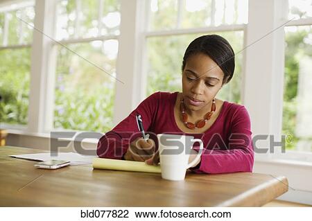 African woman working at table View Large Photo Image Stock Image - African woman working at table. Fotosearch