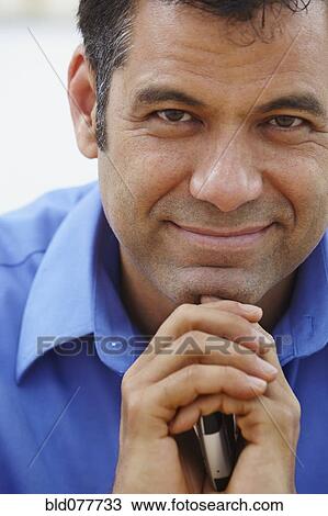 Close up of Hispanic businessman holding cell phone View Large Photo Image Stock Image - Close up of Hispanic businessman holding cell phone. Fotosearch