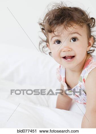 Stock Image - Hispanic baby girl crawling. Fotosearch
